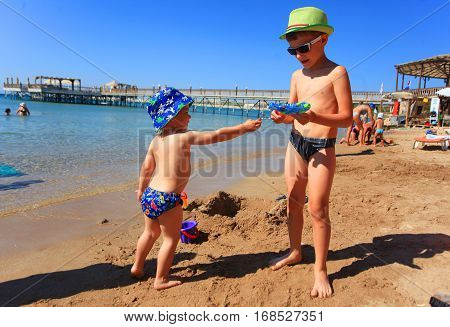 DIDIM TURKEY - JULY 9 2014. Boys playing with toys on the sea.