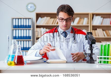 Superhero doctor working in the hospital lab