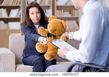 Woman with bear toy during psychologist visit