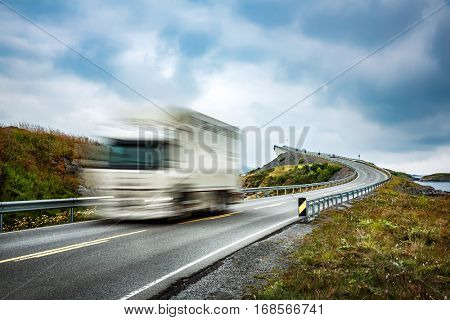 Truck and highway at sunset. Truck Car in motion blur. Atlantic Ocean Road or the Atlantic Road (Atlanterhavsveien) been awarded the title as 