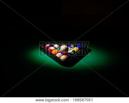 pool table in the dark with balls