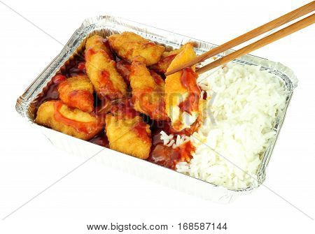 Chinese crispy battered chicken and rice with sweet and sour sauce in a foil take away tray isolated on a white background