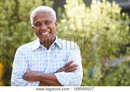 Smiling senior African American man with arms crossed