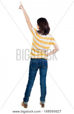 Back view of  pointing woman. beautiful brunette  girl in yellow striped t-shirt. Rear view people collection.  backside view of person.  Isolated over white background.