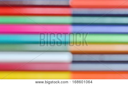out of focus multicolored vibrant colored pencils on white background