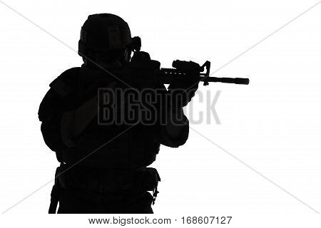 United states Marine Corps special operations command Marsoc raider with weapon aiming a gun. Silhouette of Marine Special Operator white background