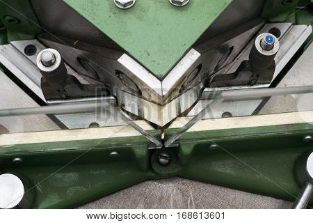 Craftsman working on frame in frameshop. Professional framer hand holding frame angle. Top view.