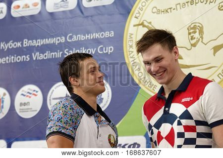 ST. PETERSBURG, RUSSIA - DECEMBER 16, 2016: Winners of X Salnikov Cup in 100 m freestyle swimming Alexander Kliukin of Russia (right) and Artyom Machekin of Belarus