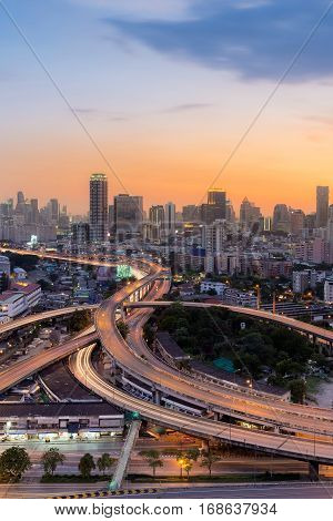 Sunset sky over highway intersection and city downtown background long exposure