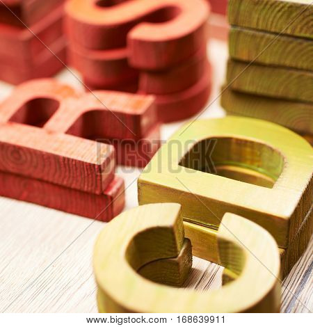 Surface coated with the multiple painted wooden block letters as an abstract backrop composition