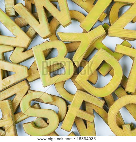Surface coated with the multiple painted wooden block letters as an abstract backrop composition