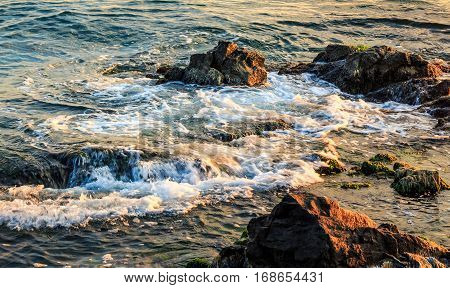 Wave Rolls Onto The Rocky Coast