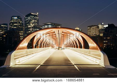 CALGARY, CANADA - AUGUST 27: Peace Bridge at night on August 27, 2015 in Calgary, Canada. Designed by Santiago Calatrava, the pedestrian bridge connect across Bow River and the landmark of the city.