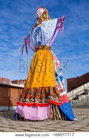 Scarecrow doll dressed in Shrovetide clothes Russian