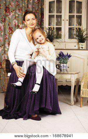 young mother with daughter at luxury home interior vintage, old fashion relashionship family