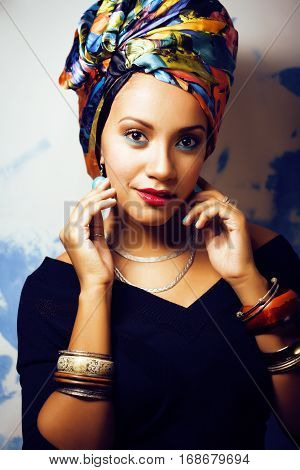 beauty bright real african woman with creative make up, shawl on head like cubian closeup smiling