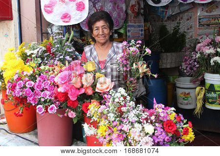 Laredo Peru - January 28 2017: Woman sells fresh flowers from flower stall at market in Laredo Peru on January 28 2017