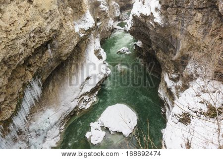 A narrow deep river valley with very steep slopes the gorge of the White river in the Republic of Adygea Russia. Snow winter cold day