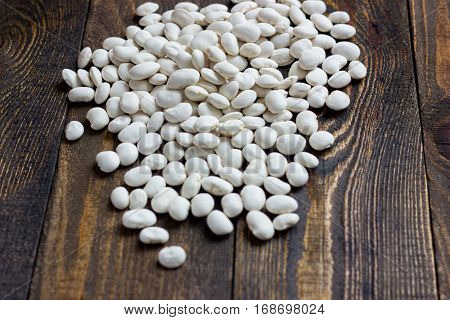 white beans on a wooden table full screen
