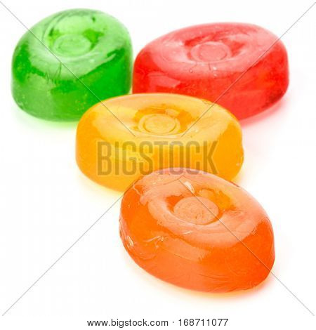 Four colorful fruit hard sugar candies,  boiled sweeties or sugar plums isolated on white background cutout.
