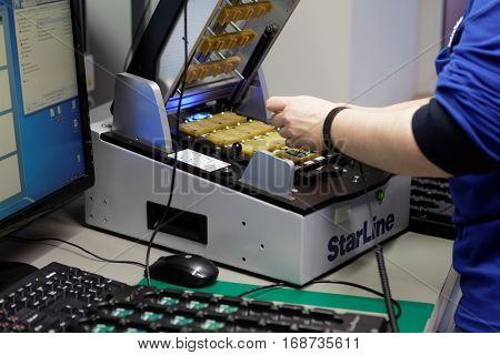 ST. PETERSBURG, RUSSIA - NOVEMBER 2, 2016: People at work on the production site of StarLine company. It is one of the leading company on the automotive security market of Russia
