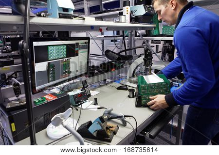 ST. PETERSBURG, RUSSIA - NOVEMBER 2, 2016: People at work on the production site of StarLine company. It is one of the leading company on the automotive security market of Russia