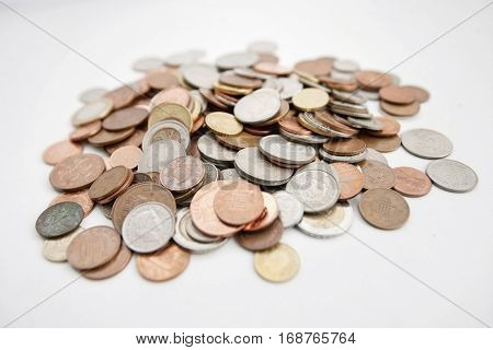 Close-up of large group of coins over white background