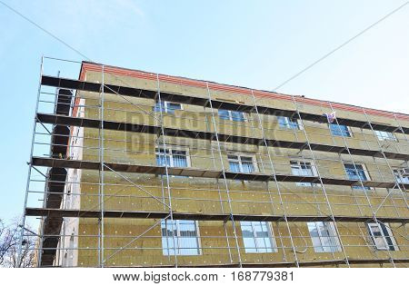 Exterior house wall heat insulation with mineral wool building under construction. The more heat flow resistance your insulation provides the lower your heating and cooling costs.