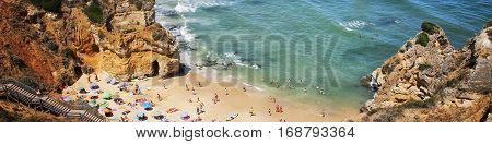 Algarve coastline in Portugal. Famous Camilo Beach in Lagos, Algrave, Portugal. Popular touristic place in Portugal, ocean beach