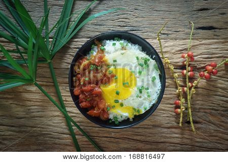 Rice With Fried Egg And Tomato Sauce On Table Vintage Wooden Surface Top View