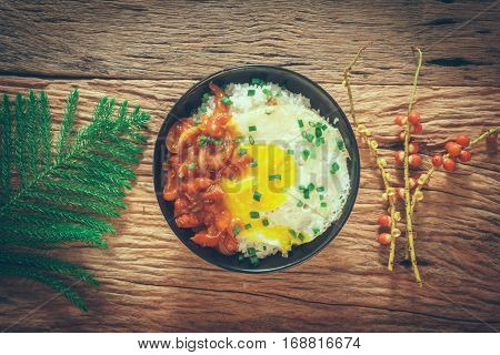 Rice With Fried Egg And Tomato Sauce On Table Vintage Wooden Surface Top View
