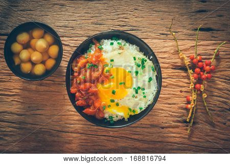 Rice With Fried Egg And Tomato Sauce On Table Vintage Wooden Surface Top View
