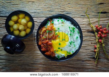 Rice With Fried Egg And Tomato Sauce On Table Vintage Wooden Surface Top View