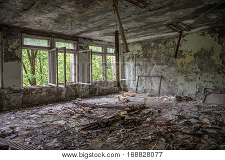 empty school class with debris and broken windows in forsaken Pripyat