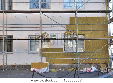 KIEV UKRAINE - January 23 2017: Energy efficiency house wall renovation for energy saving. Exterior house wall heat insulation with mineral wool building hospital under construction.