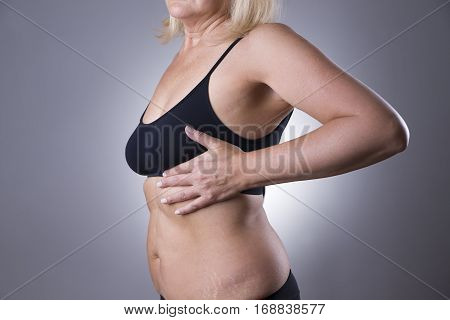 Breast test woman examining her breasts for cancer heart attack pain in human body on gray background