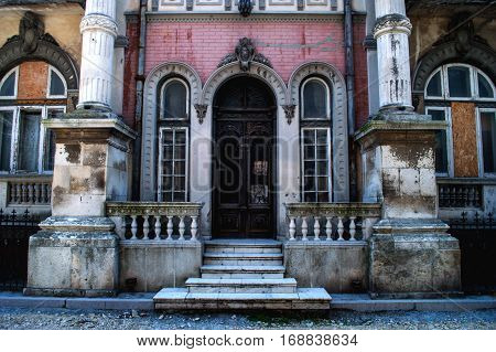 Facade with columns of an old dilapidated building in the city center.