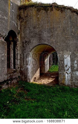 Light pours through the entrance arch to the old military building.