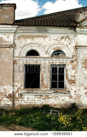 Two windows in the old dilapidated building.