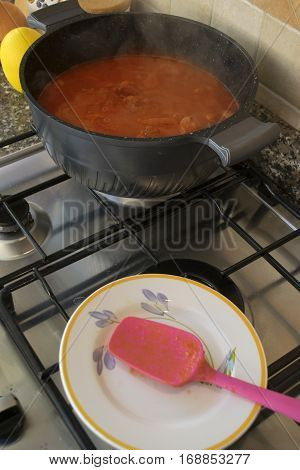 cooking gulash in casserole on gas ring