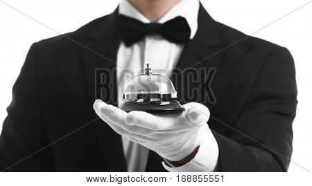 Bellboy holding bell on his hand, close up