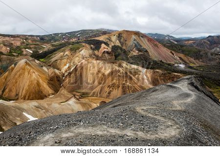 Colorful Landmanallaugar mountains in the Fajllabak Nature Reserve in the Highlands of Iceland - hiking trail form Blahnukur lava field wich was formad in an eruption popular destination for tourist an with many hiking trails.