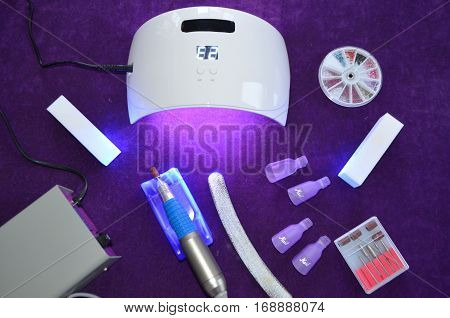 Nail gel salon. Beautiful woman hand and lamp UV  for nails UV with timer