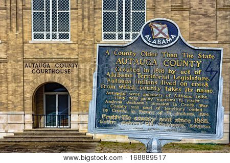 Prattville Alabama USA - January 28 2017: Close of up the Alabama Historical Association historic marker for Autauga County with the Autauga County courthouse in the background.