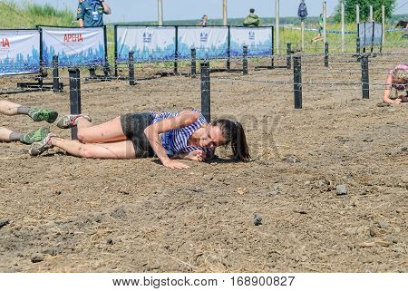 Tyumen, Russia - July 9, 2016: Steel Character extrim race on Voronino Hill. Army Test. People jumping, crawling, passing under a barbed wires or climbing obstacles during extreme obstacle race