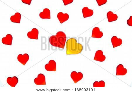 Bright red hearts on a striped background with yellow and red hearts. In order to use Valentine's Day, weddings, International Women's Day