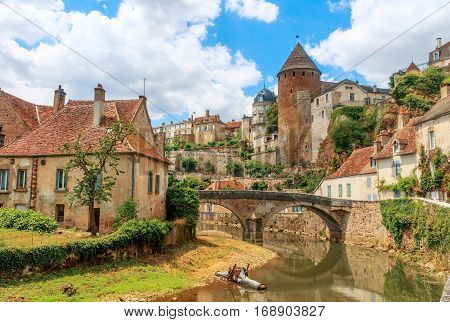 Quaint river through the medieval town of Semur en Auxois Burgundy France