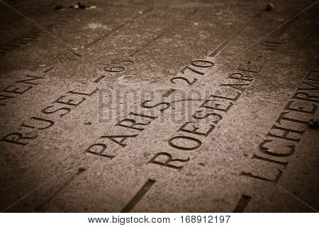 Many ways to many places signs on the old stone plate.