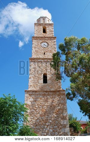 The old stone clock tower at Emborio on the Greek island of Halki. Broken for many years, the clock is always at twenty past four.