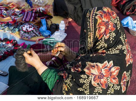 Muscat Oman February 4th 2017: omanya making yarn out of wool